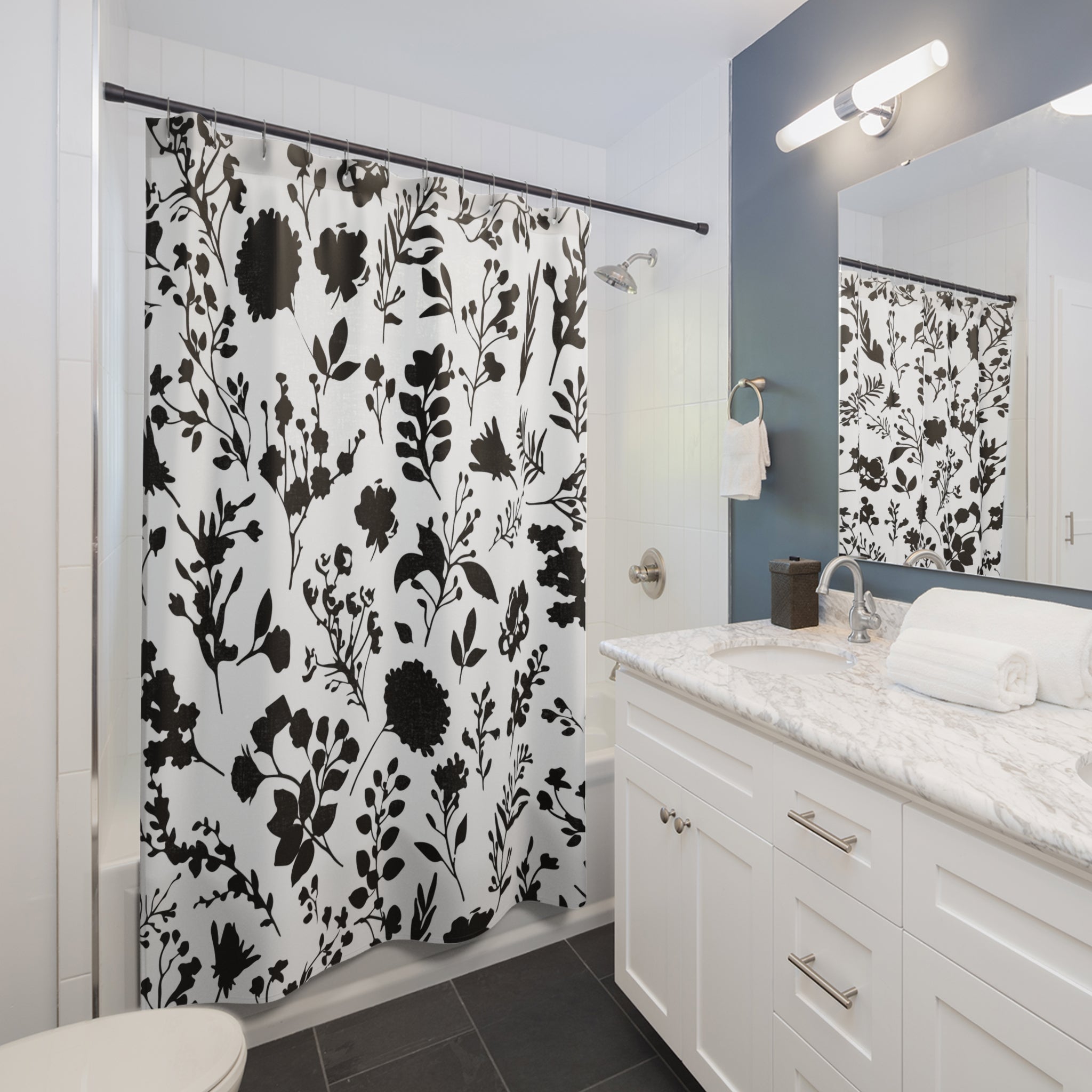 a bathroom with a floral shower curtain in it