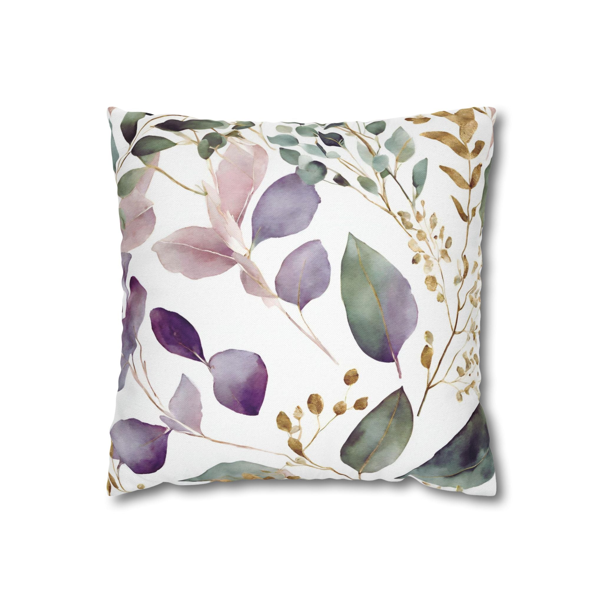 a square pillow with a white background and a pattern of purple and green leaves and flowers.