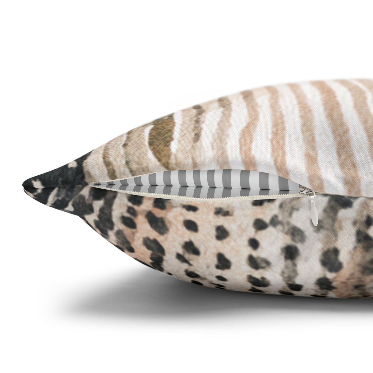 A close-up view of a decorative pillow with a zippered pocket, featuring a pattern of brown and black stripes.
