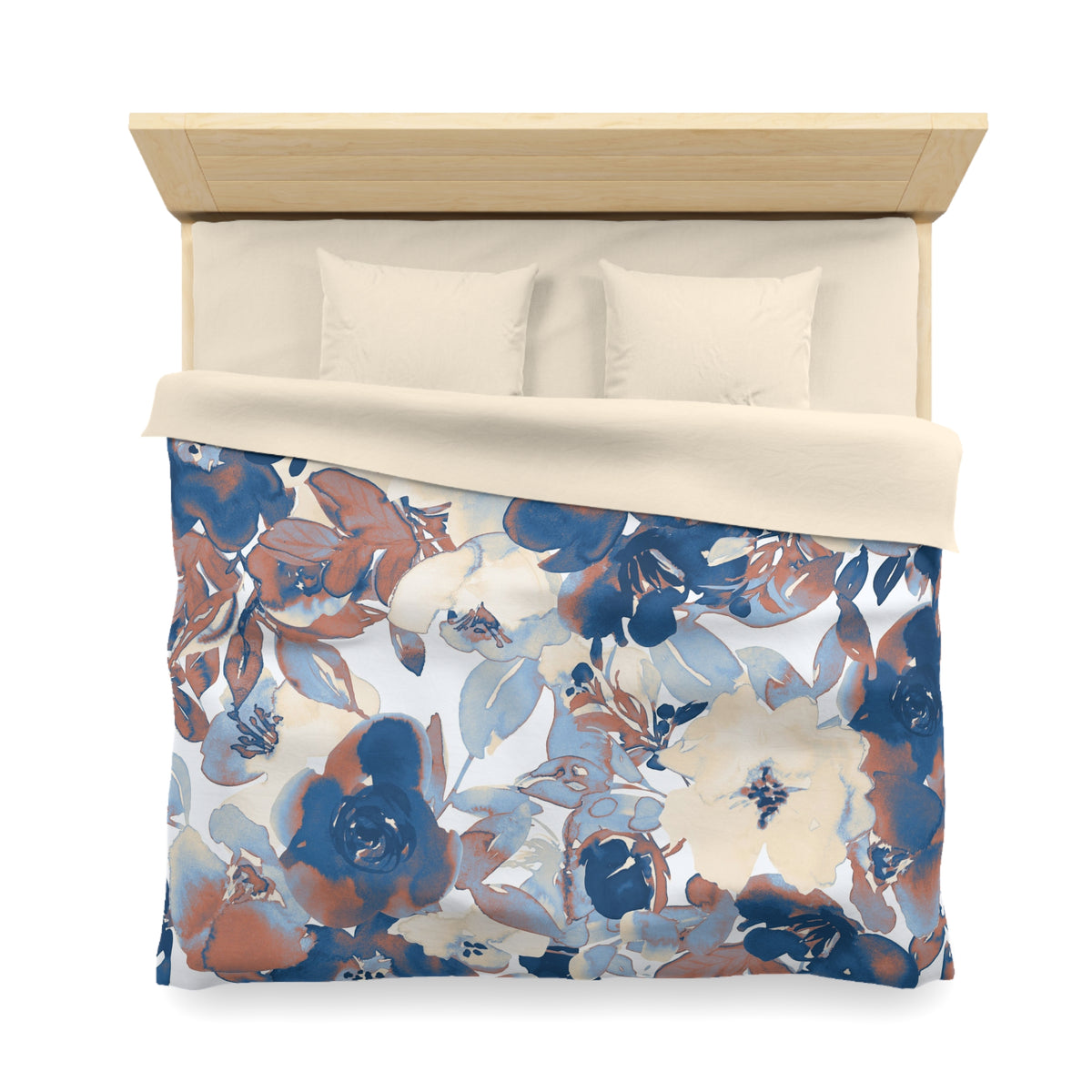 a bed with a floral print comforter and pillows.