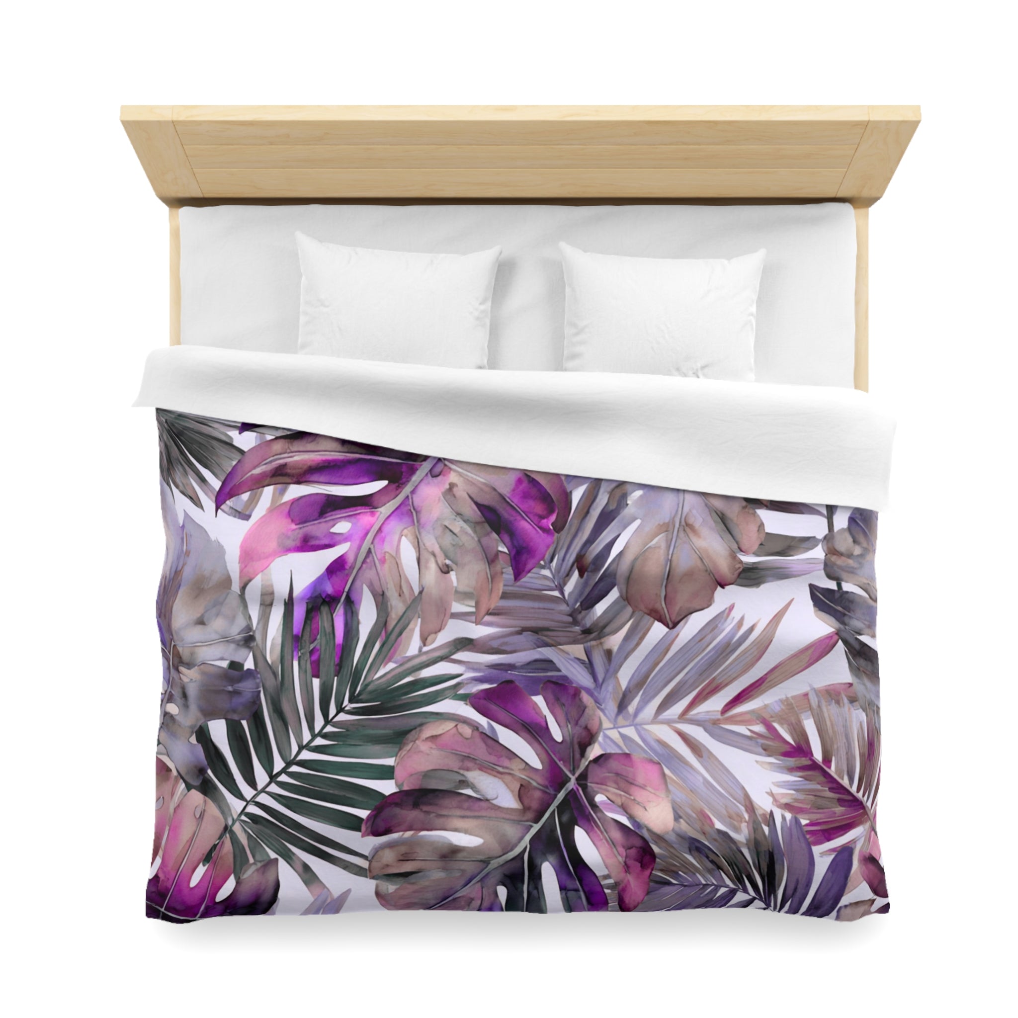 a bed with a colorful, tropical-themed bedspread featuring a pattern of purple and green leaves.