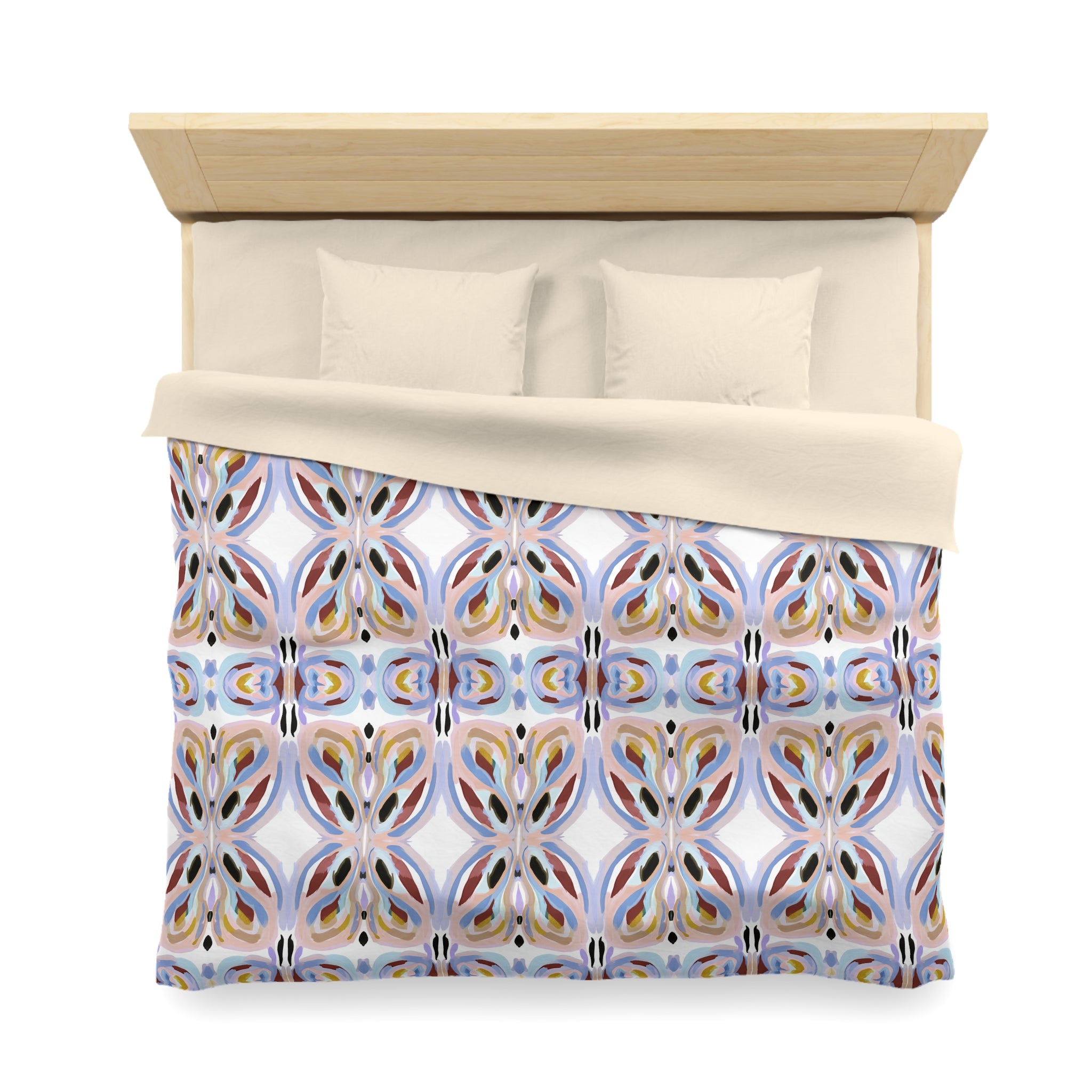 a bed with a colorful, patterned comforter and pillows.