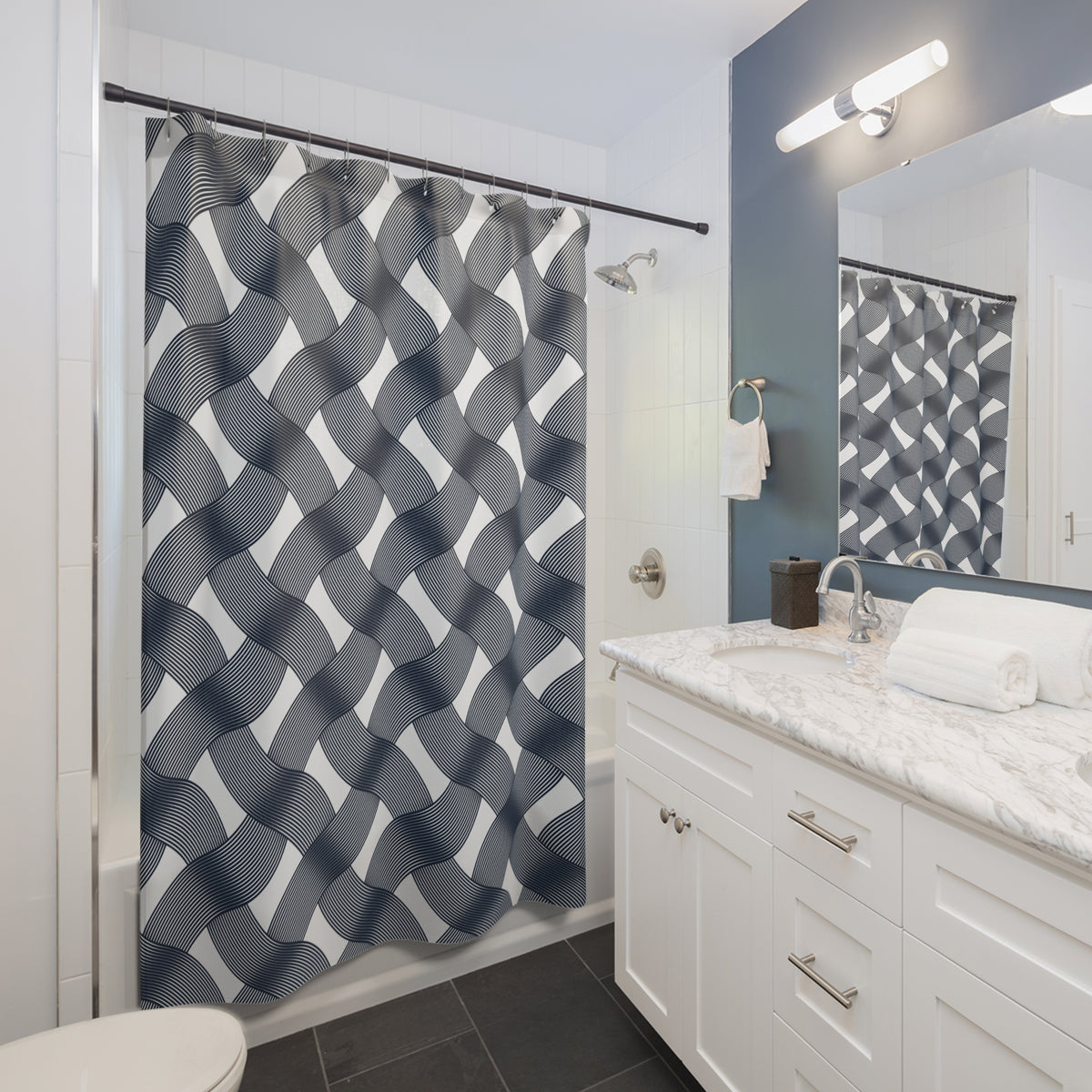 a modern bathroom with a white vanity, a black and white patterned shower curtain, and a mirror above the vanity.