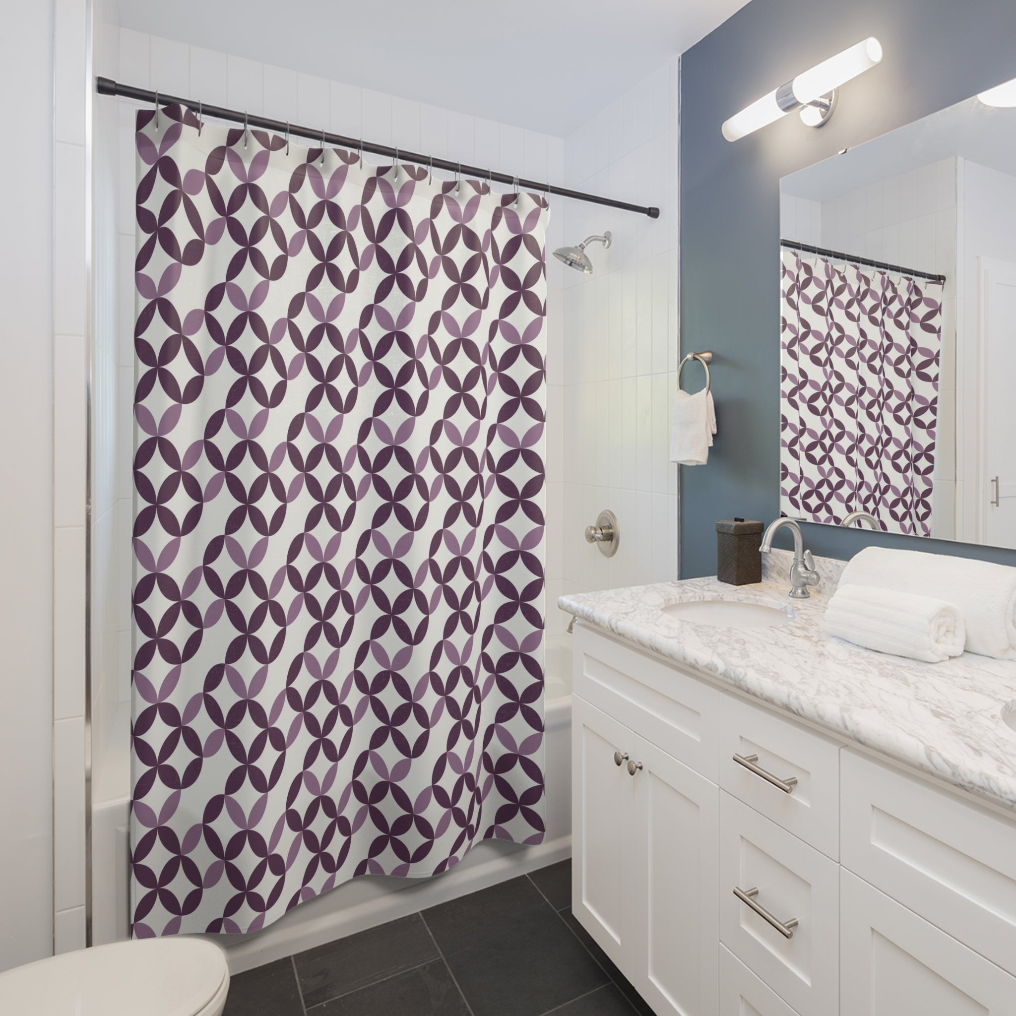 a modern bathroom with a white vanity, a shower with a purple and white patterned shower curtain, and a mirror above the vanity.