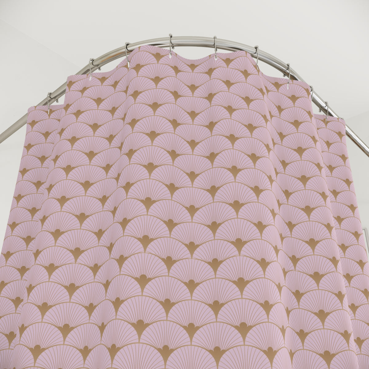a pink and gold patterned shower curtain hanging from a curved metal rod.