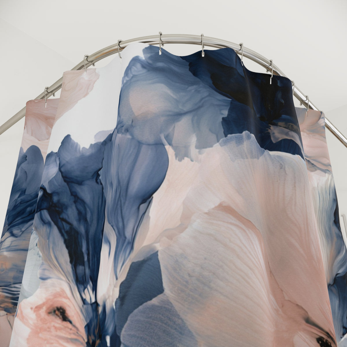 a blue and pink curtain hanging from a metal pole