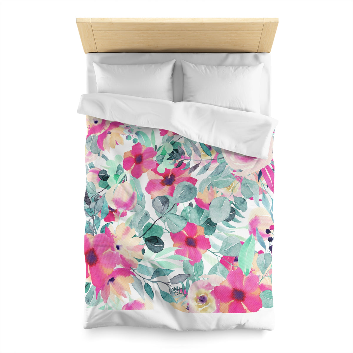 a bed with a floral print duvet cover and pillows.