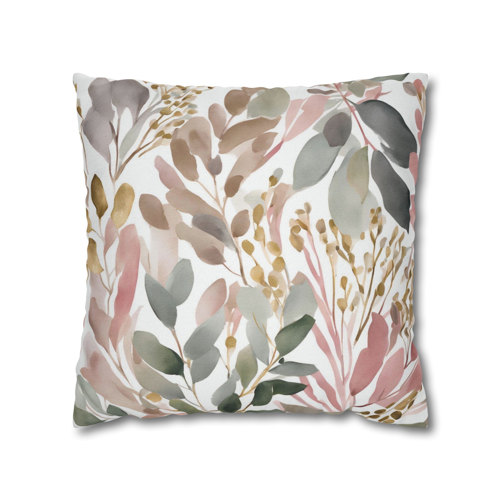 a square pillow with a floral pattern of leaves and flowers in various shades of green, pink, and brown.