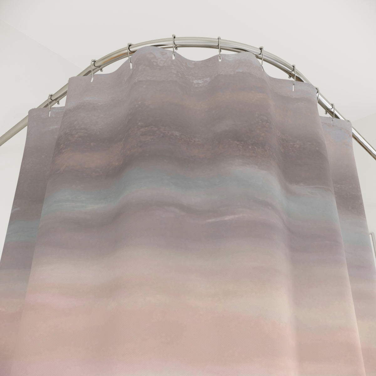 a shower curtain with a gradient design, featuring a blend of pink and blue colors. The curtain is hanging from a rod, and the background appears to be a white wall.