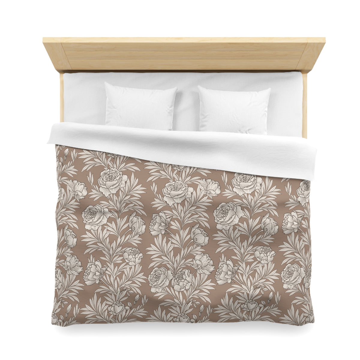 a neatly made bed with a floral patterned comforter and two white pillows.