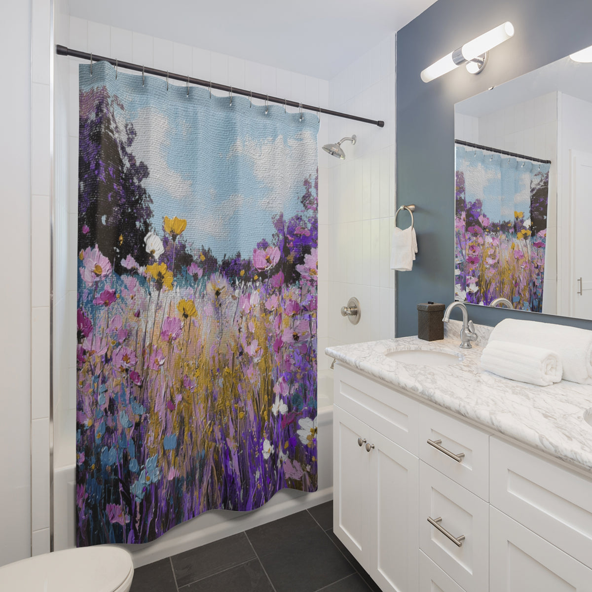 A bathroom with a shower curtain featuring a colorful floral pattern. The shower curtain is hanging in the shower area, and the bathroom has a white vanity and marble countertop.