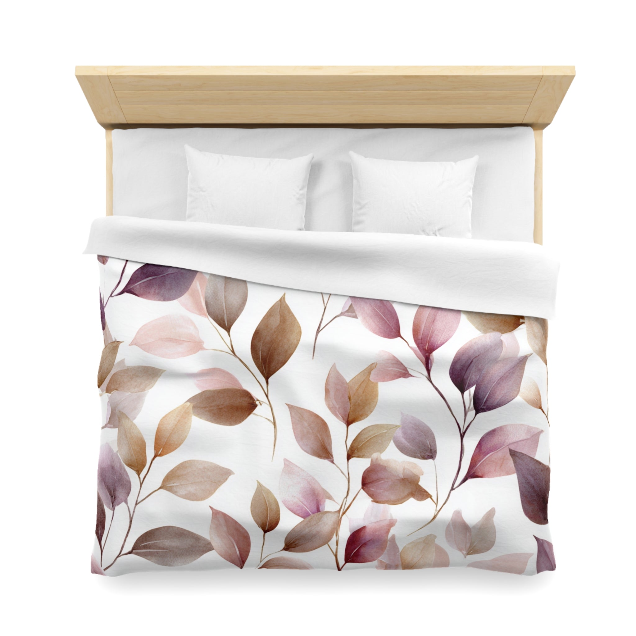a neatly made bed with a white comforter and a leaf-patterned duvet cover.