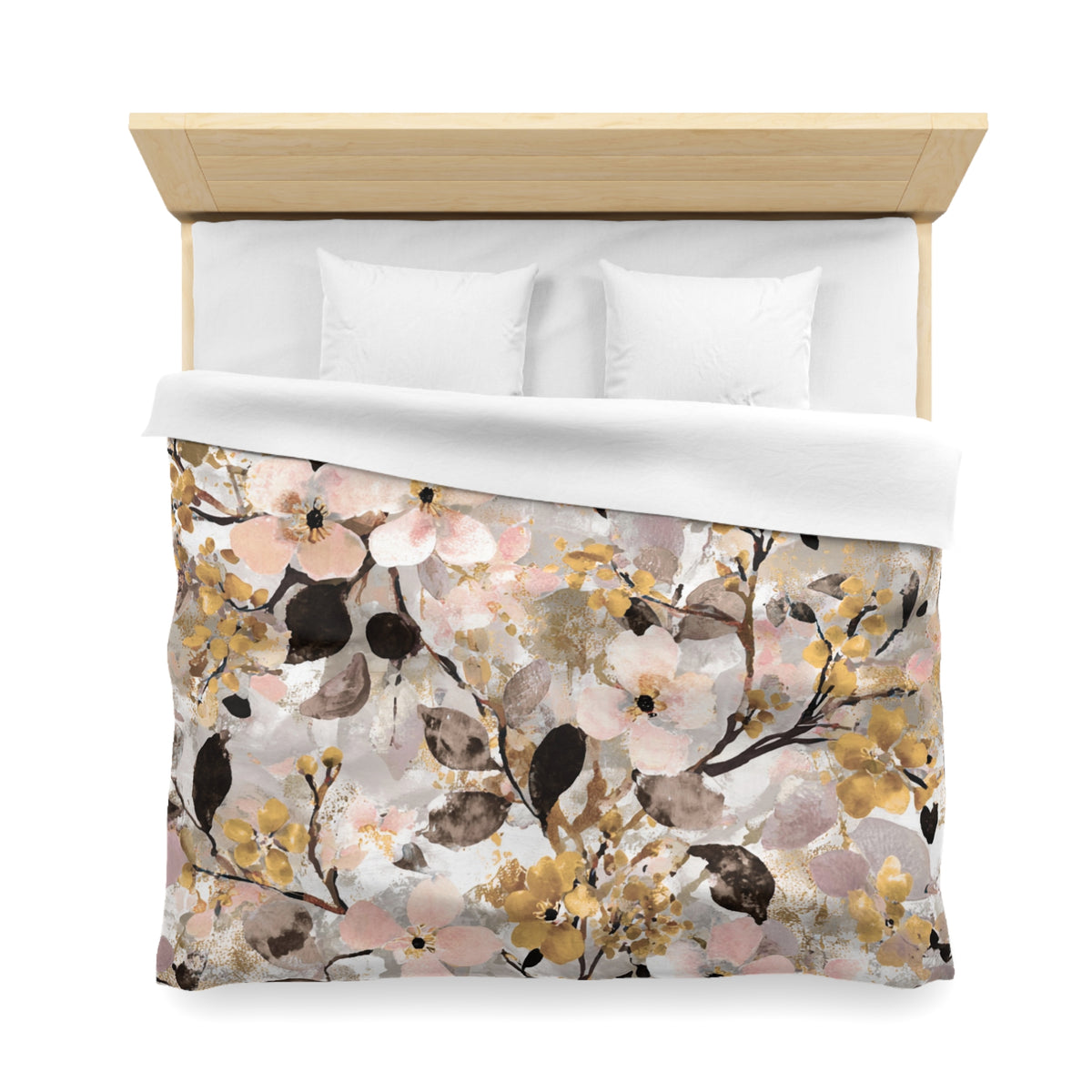 a bed with a floral print duvet cover and pillows.