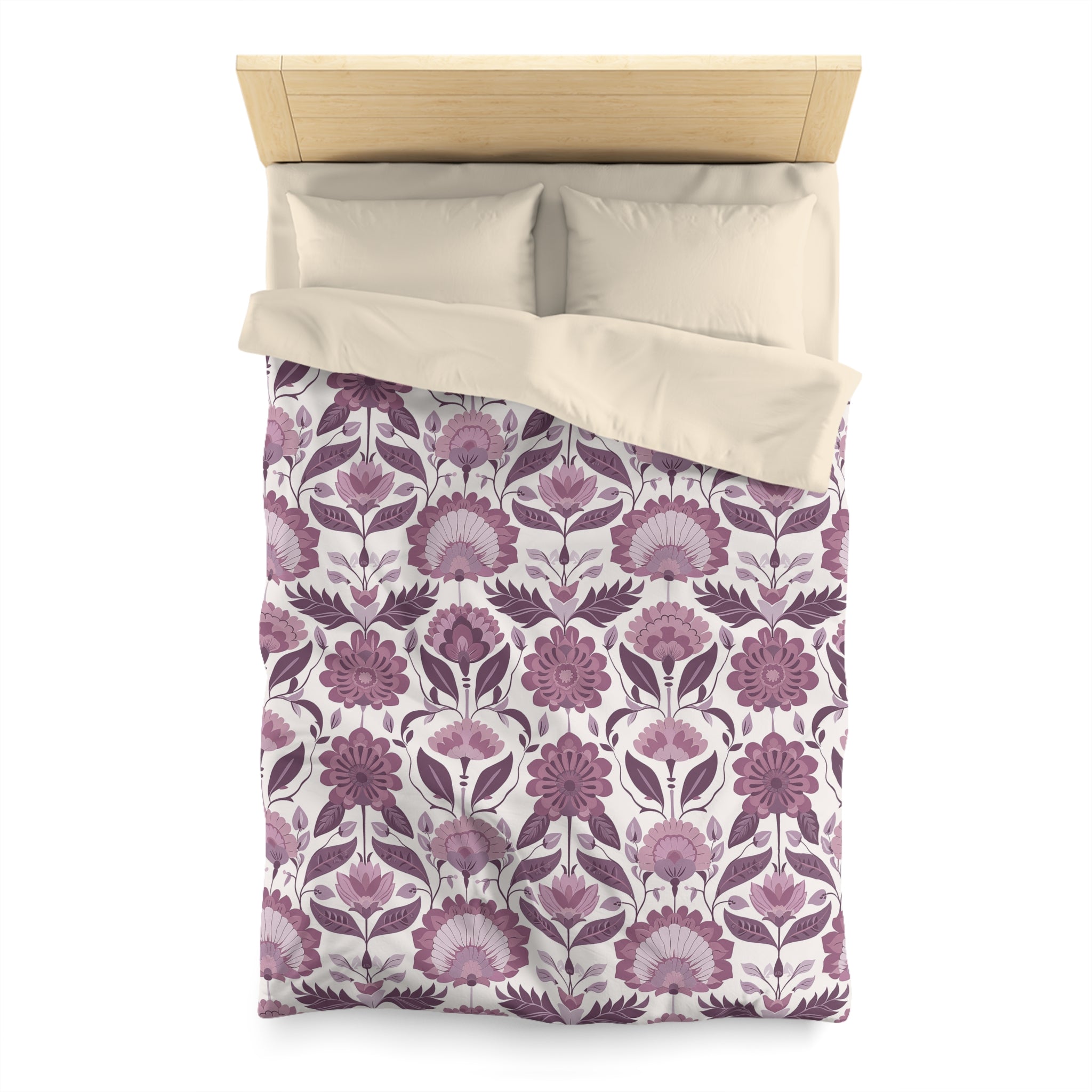 a bed with a floral patterned comforter and pillows.