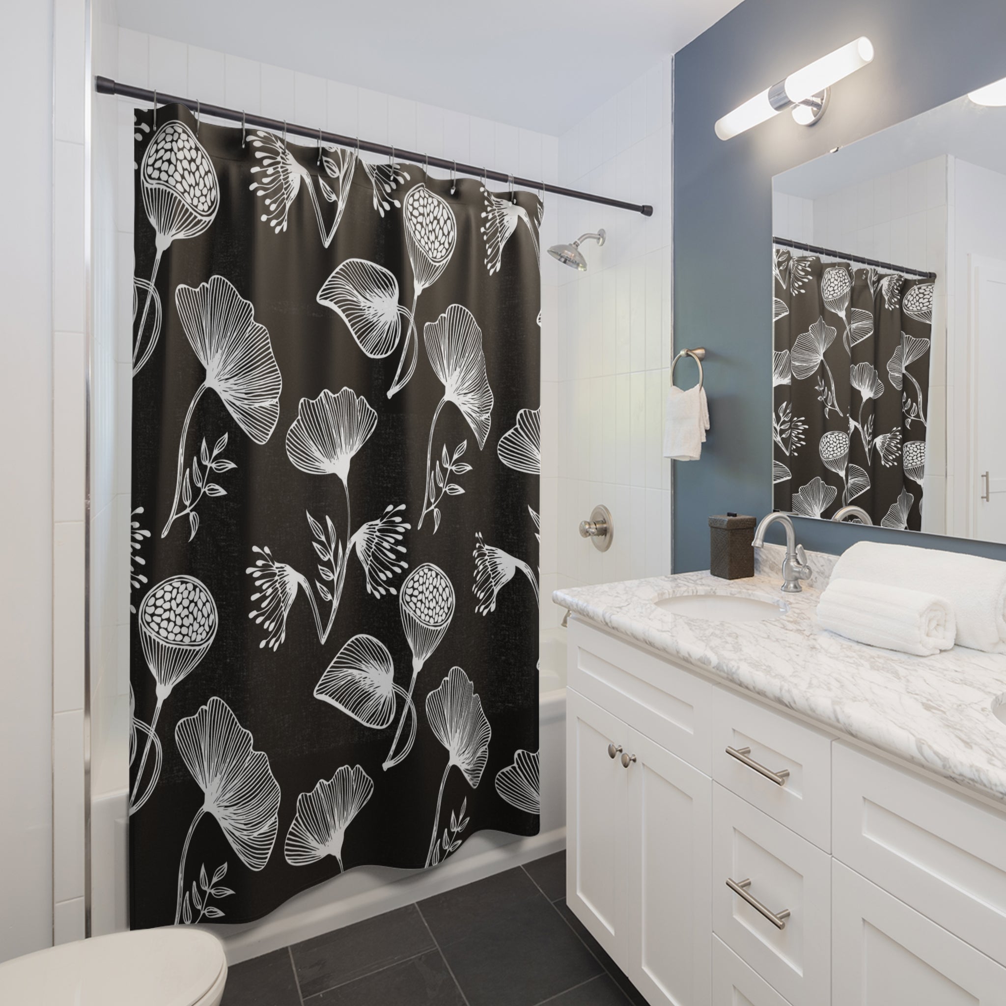 a bathroom with a black and white modern shower curtain