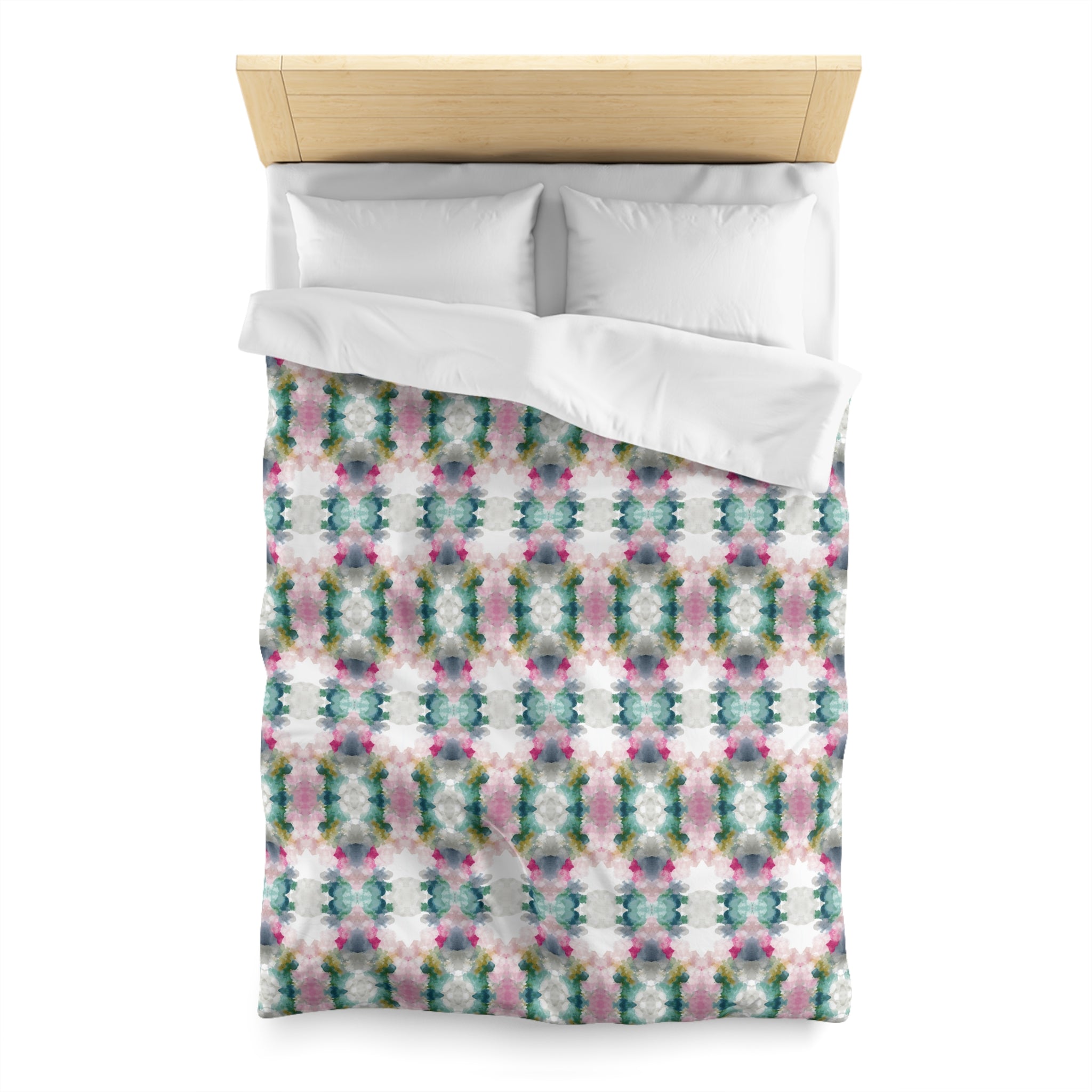 a bed with a colorful, patterned comforter and pillows.