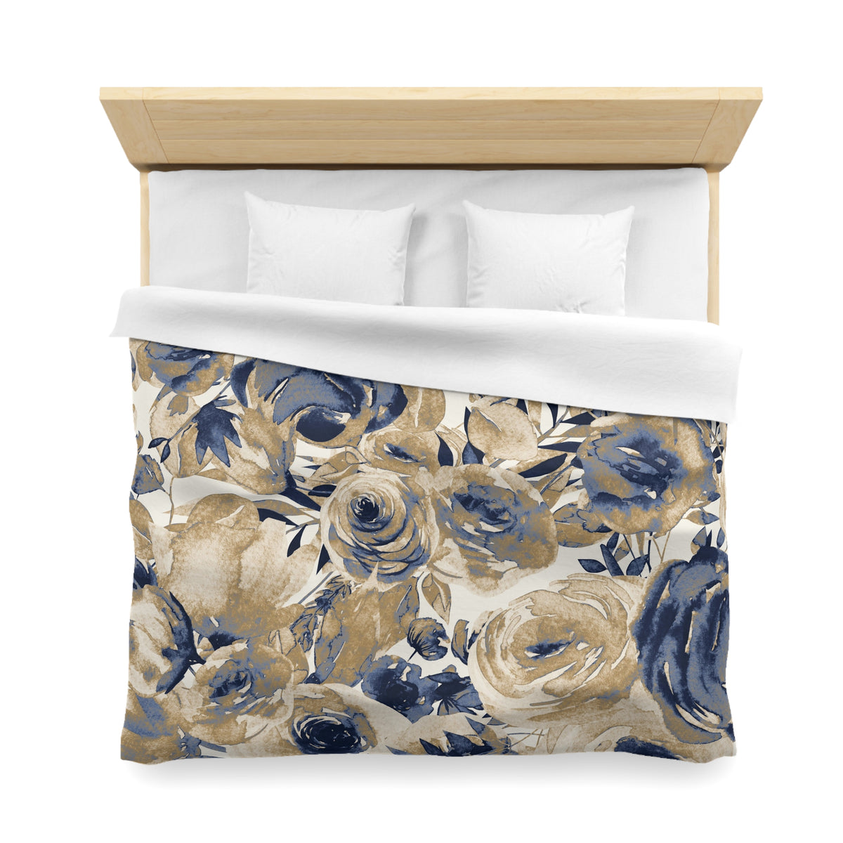 a bed with a floral print duvet cover and white pillows.