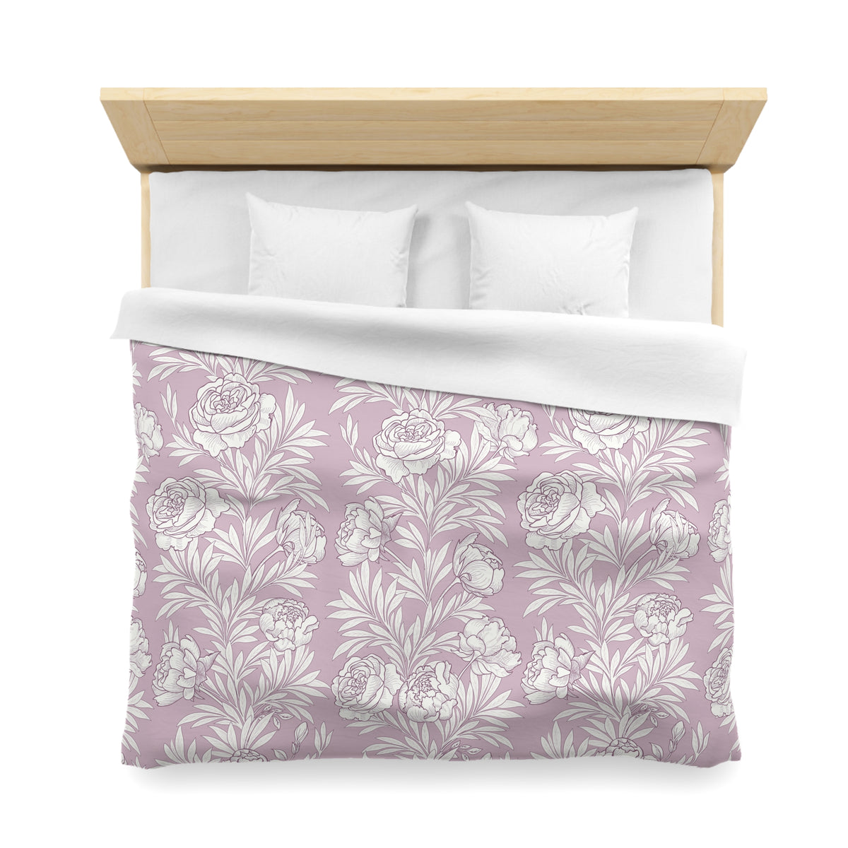 a neatly made bed with a floral patterned comforter and pillows.