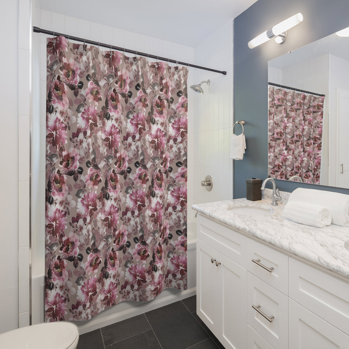 a modern bathroom with a white vanity, a shower curtain with a floral pattern, and a mirror above the vanity.