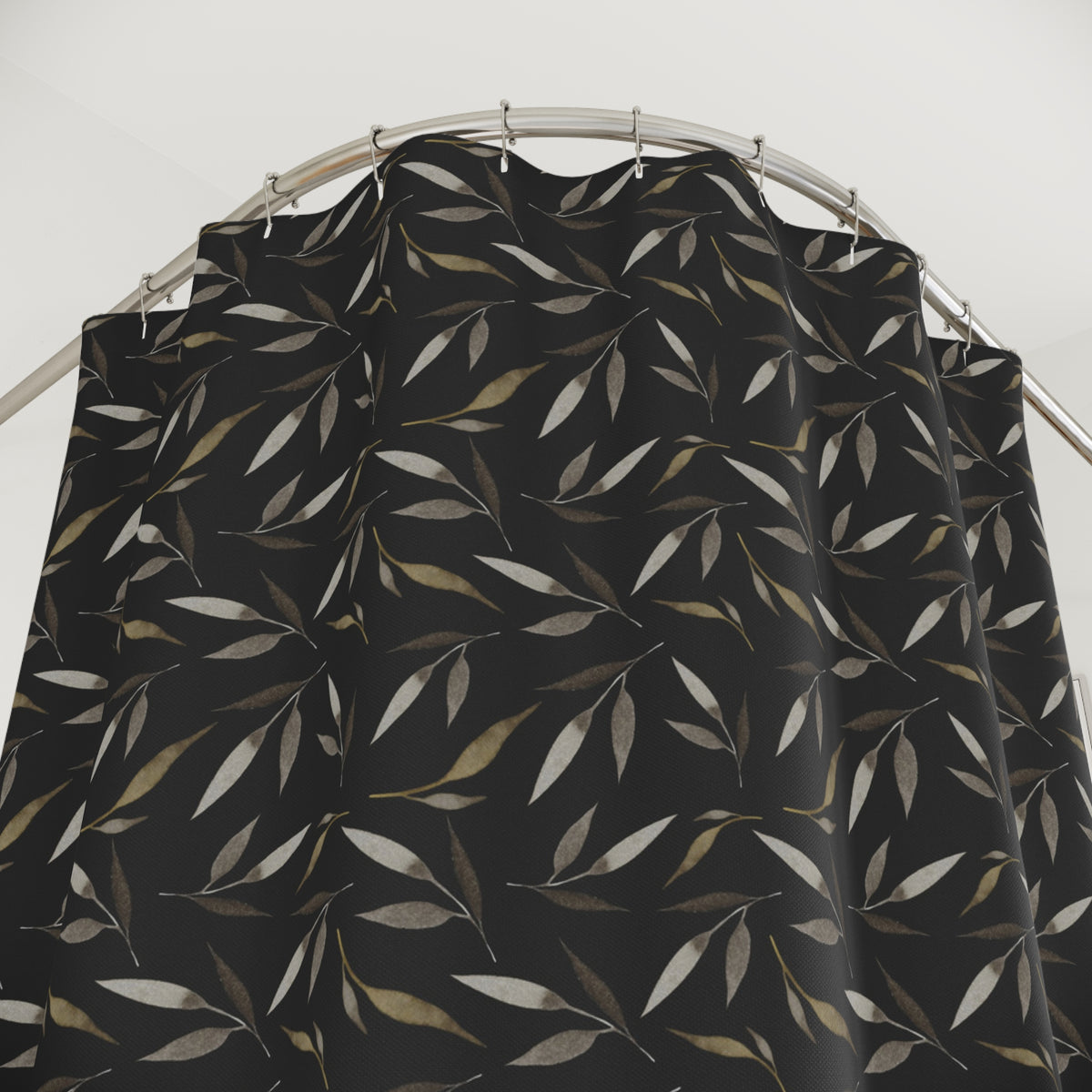 a black shower curtain with a repeating leaf pattern in shades of brown and beige.