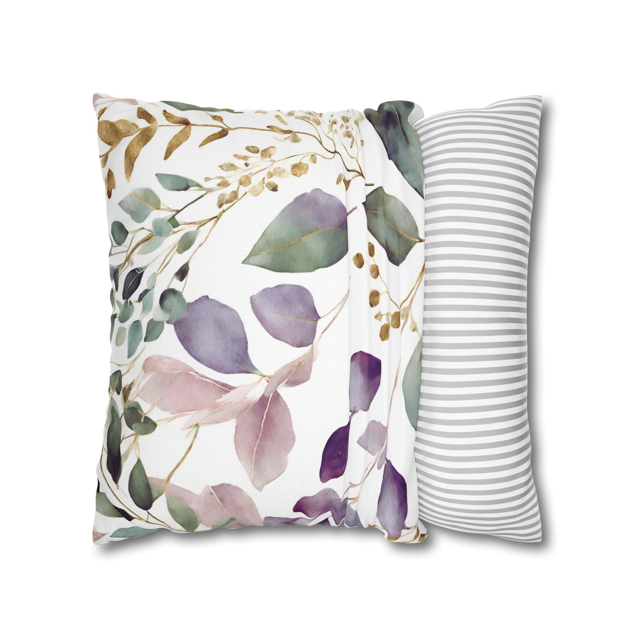 a decorative pillow with a floral print design, including leaves and flowers in various shades of green, purple, and pink.
