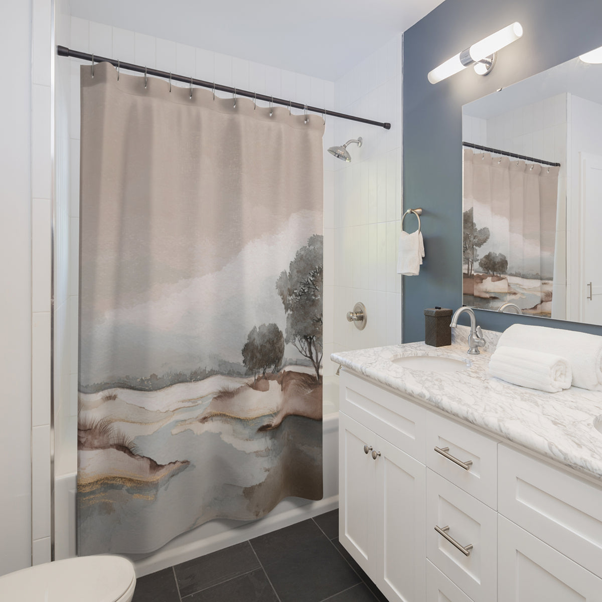 a modern bathroom with a shower curtain featuring a landscape scene, a white sink with a marble countertop, and a mirror above the sink.