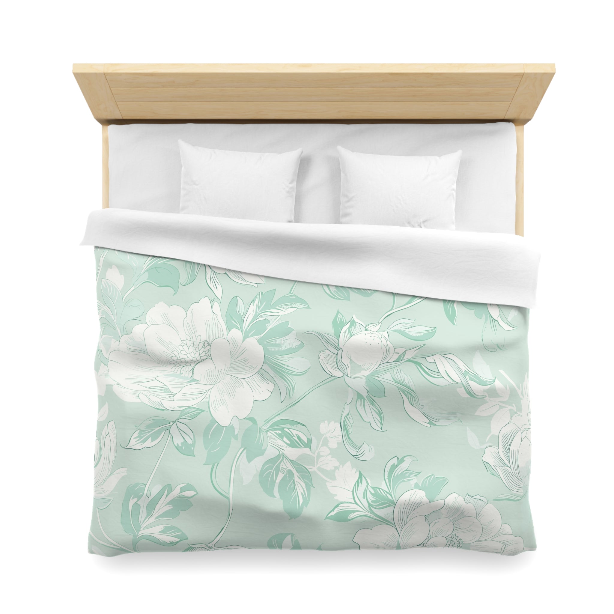 a neatly made bed with a floral patterned comforter and pillows.