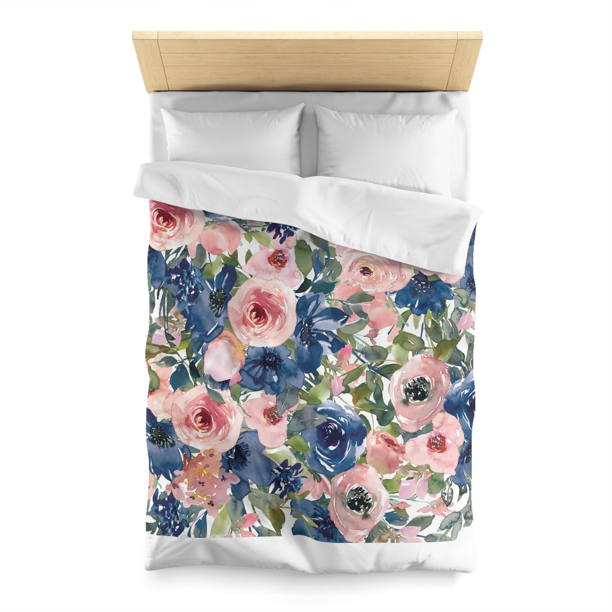 a bed with a floral print duvet cover featuring a variety of pink, blue, and green flowers.