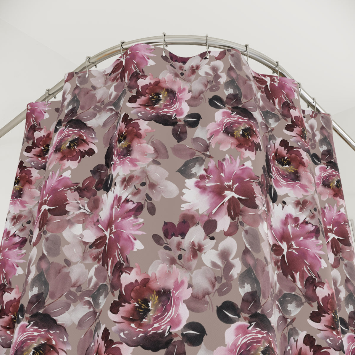 a shower curtain with a floral pattern in shades of pink and purple.