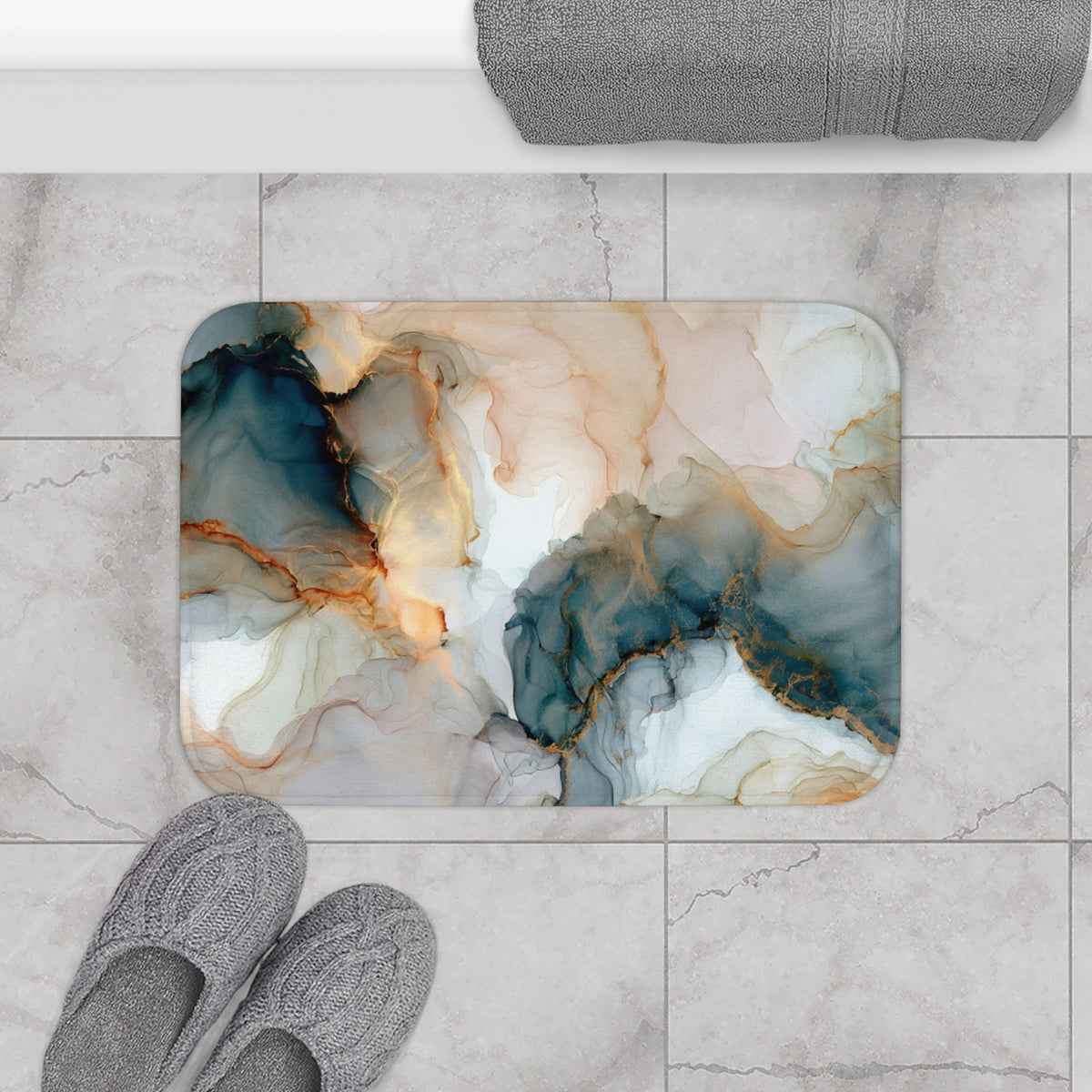 a bathroom floor with a marble-like tile pattern, a pair of gray slippers, and a rolled-up gray towel.