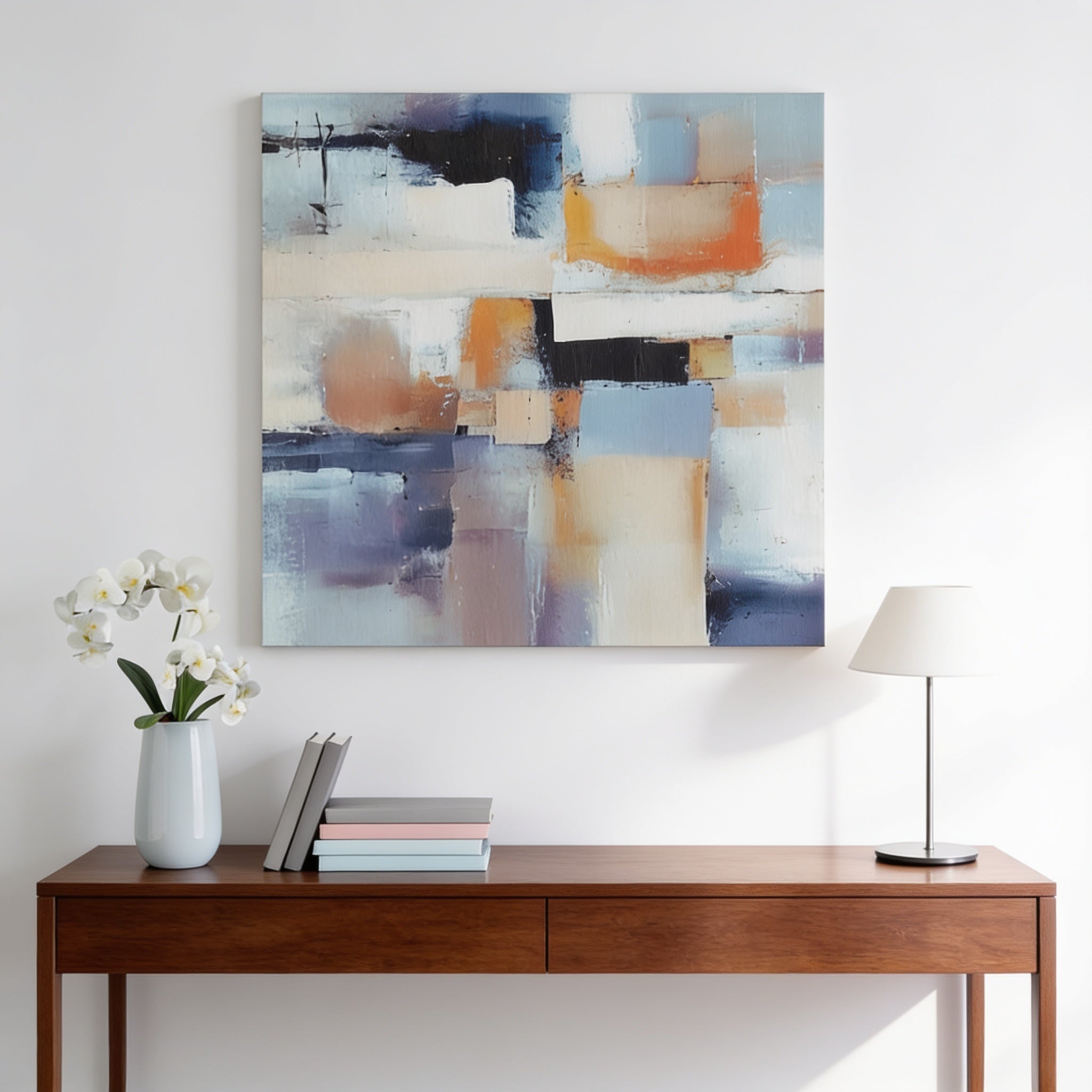 a wooden console table with a vase of white flowers, a stack of books, and a lamp on top. Above the table, there is a large abstract painting hanging on the wall.