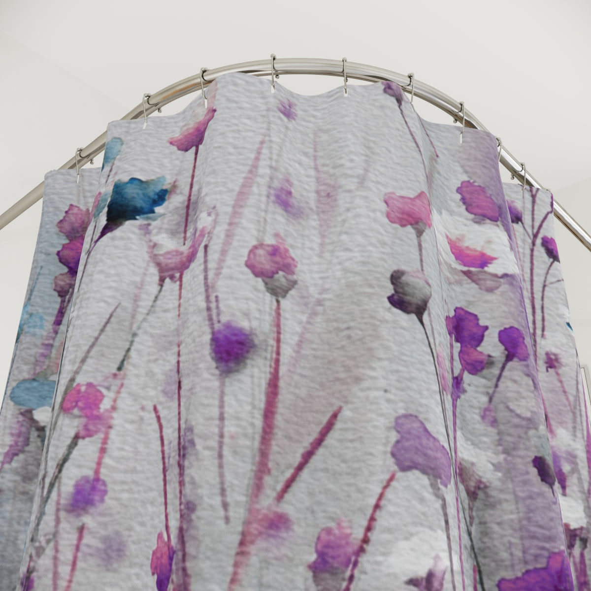 a shower curtain with a floral pattern in shades of purple and blue.