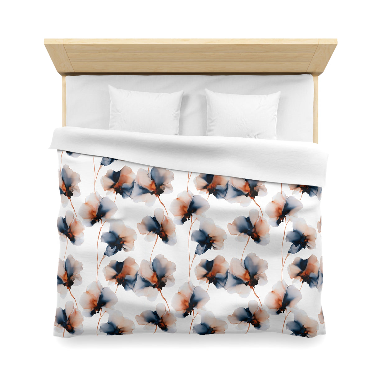 a bed with a floral patterned comforter and pillows.