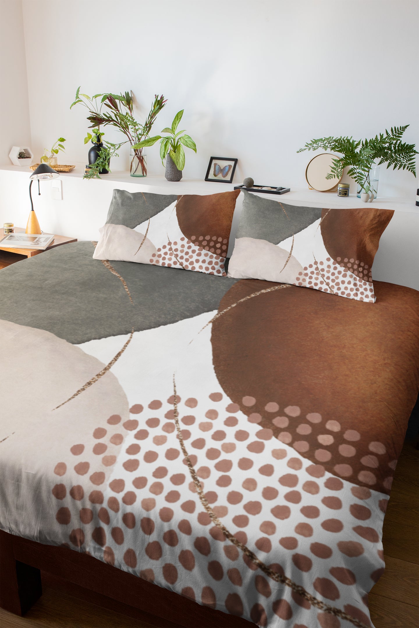 a bed with a brown and white comforter and pillows