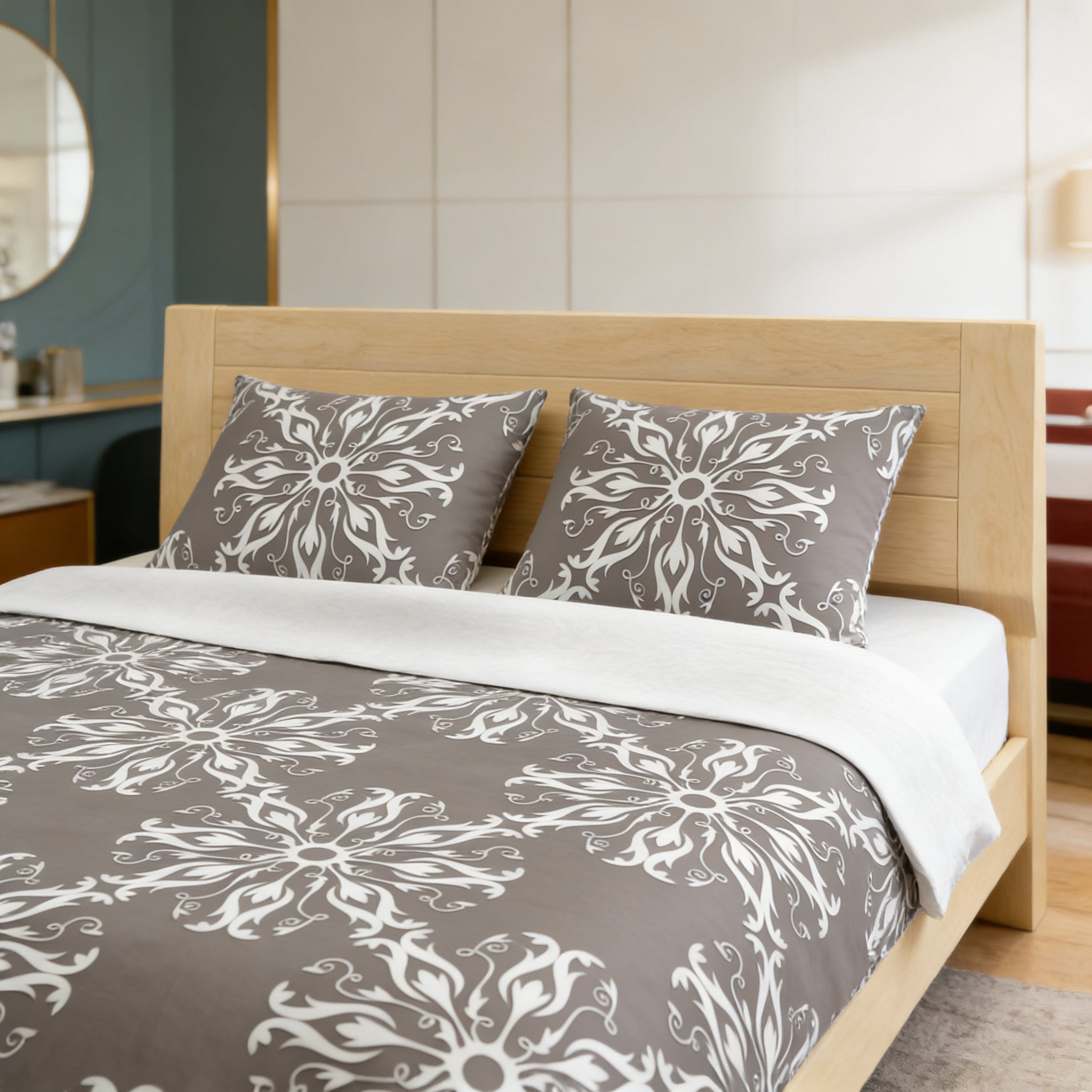 a modern bedroom with a wooden bed frame and a gray and white patterned comforter. The bed is neatly made with a white blanket and two matching pillows. The room has a clean and minimalist design, with white walls and a wooden floor.