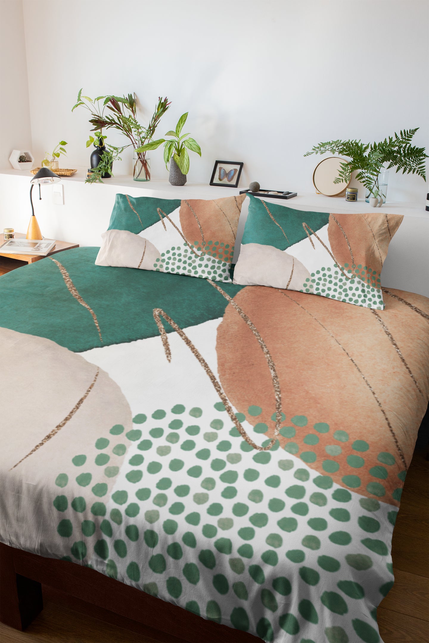 a bed with a green and white comforter and pillows