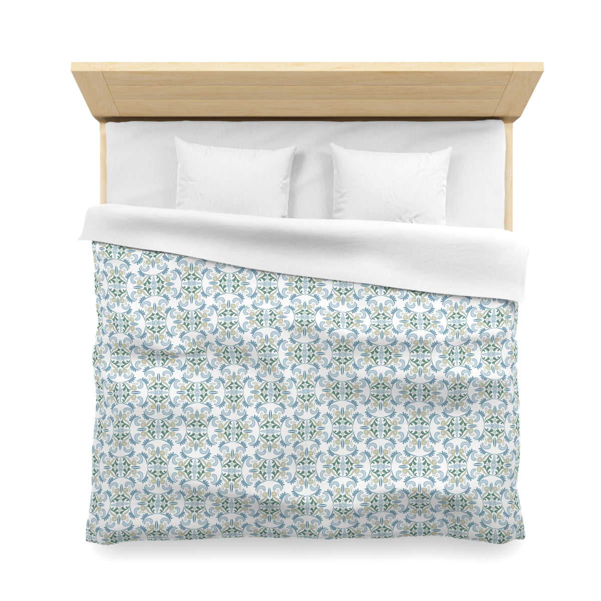 a neatly made bed with a patterned comforter and two pillows.