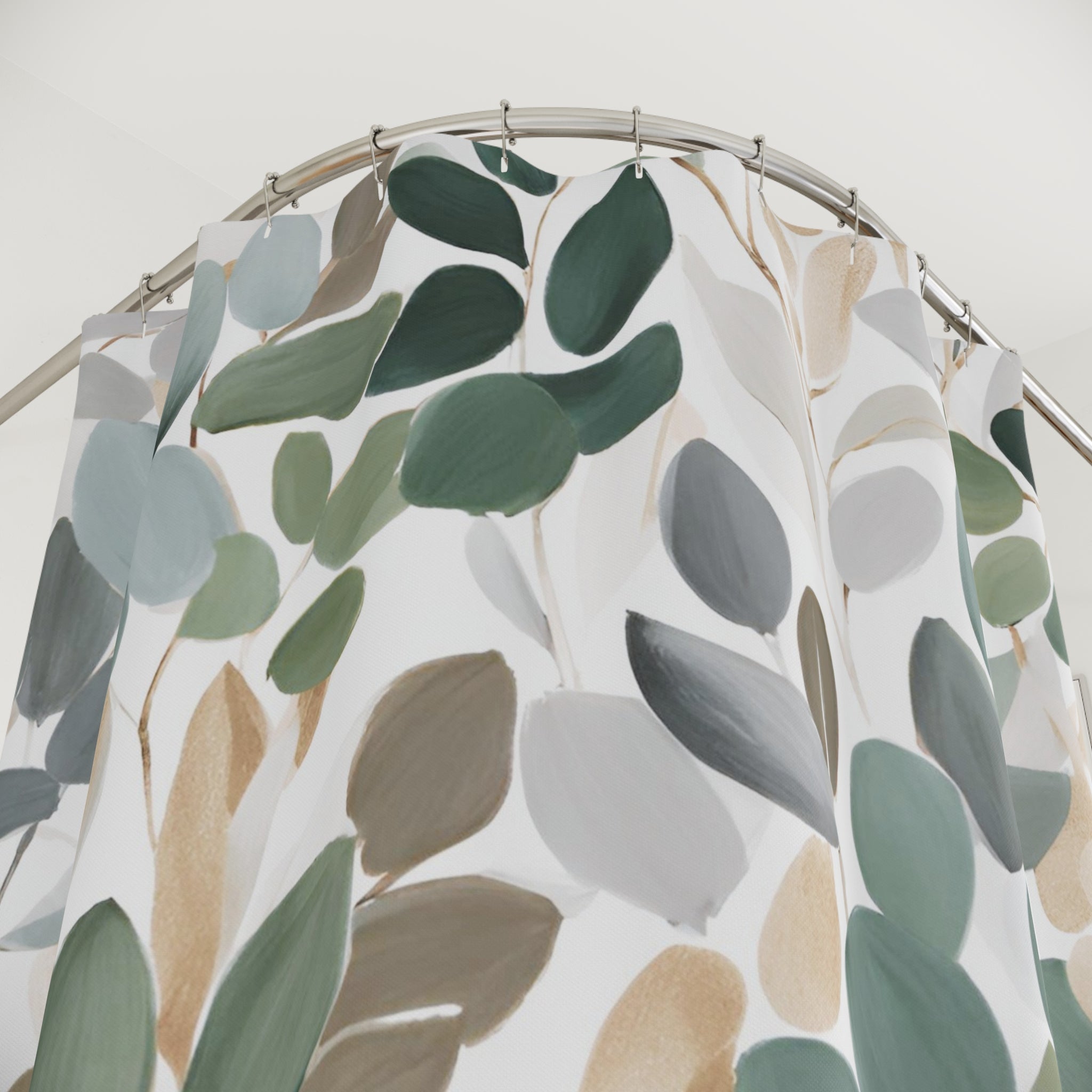 a shower curtain with a leafy pattern in various shades of green, gray, and brown.