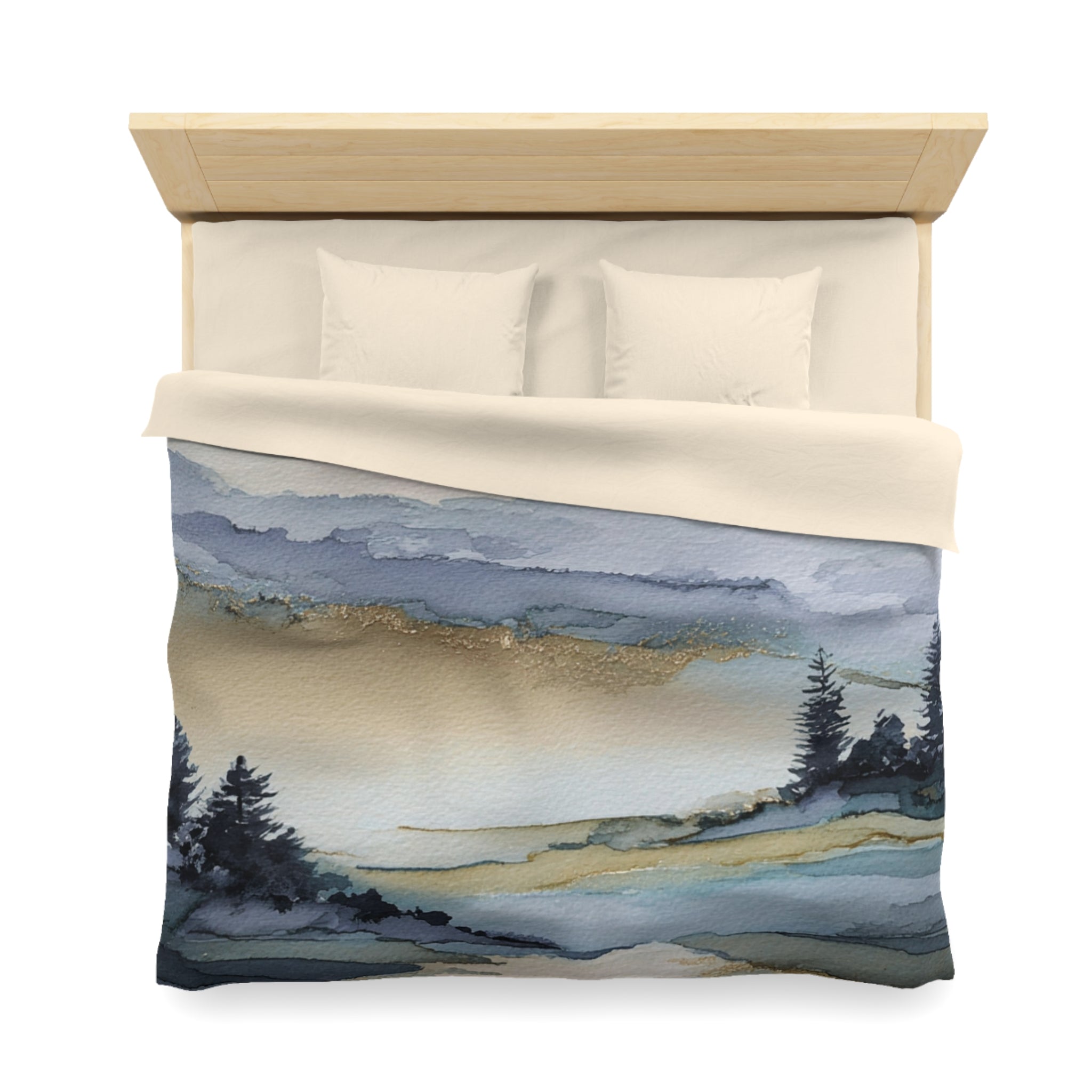 a bed with a blue and white watercolor landscape print on the comforter, depicting a serene mountain scene with pine trees and a body of water.