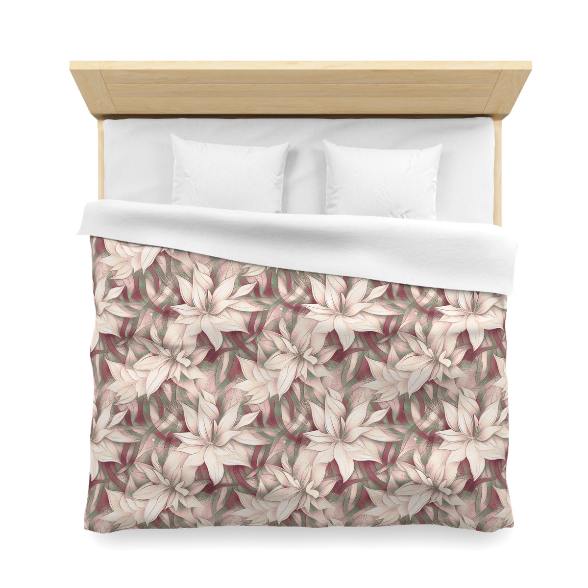 a neatly made bed with a floral patterned comforter and two white pillows.