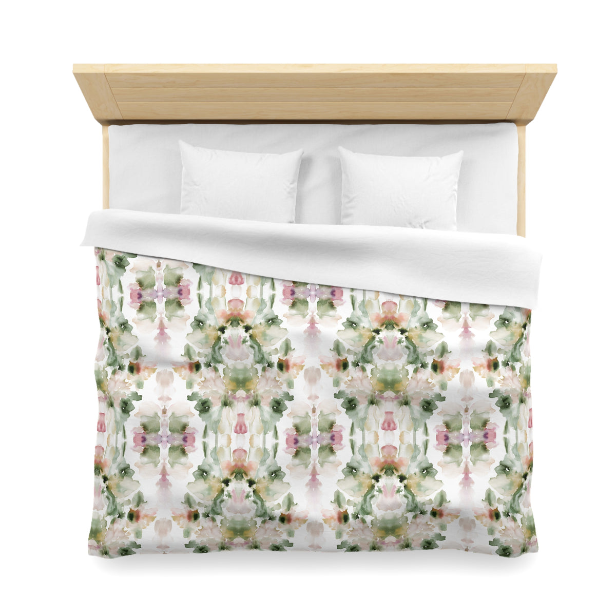 a bed with a floral patterned comforter and pillows.