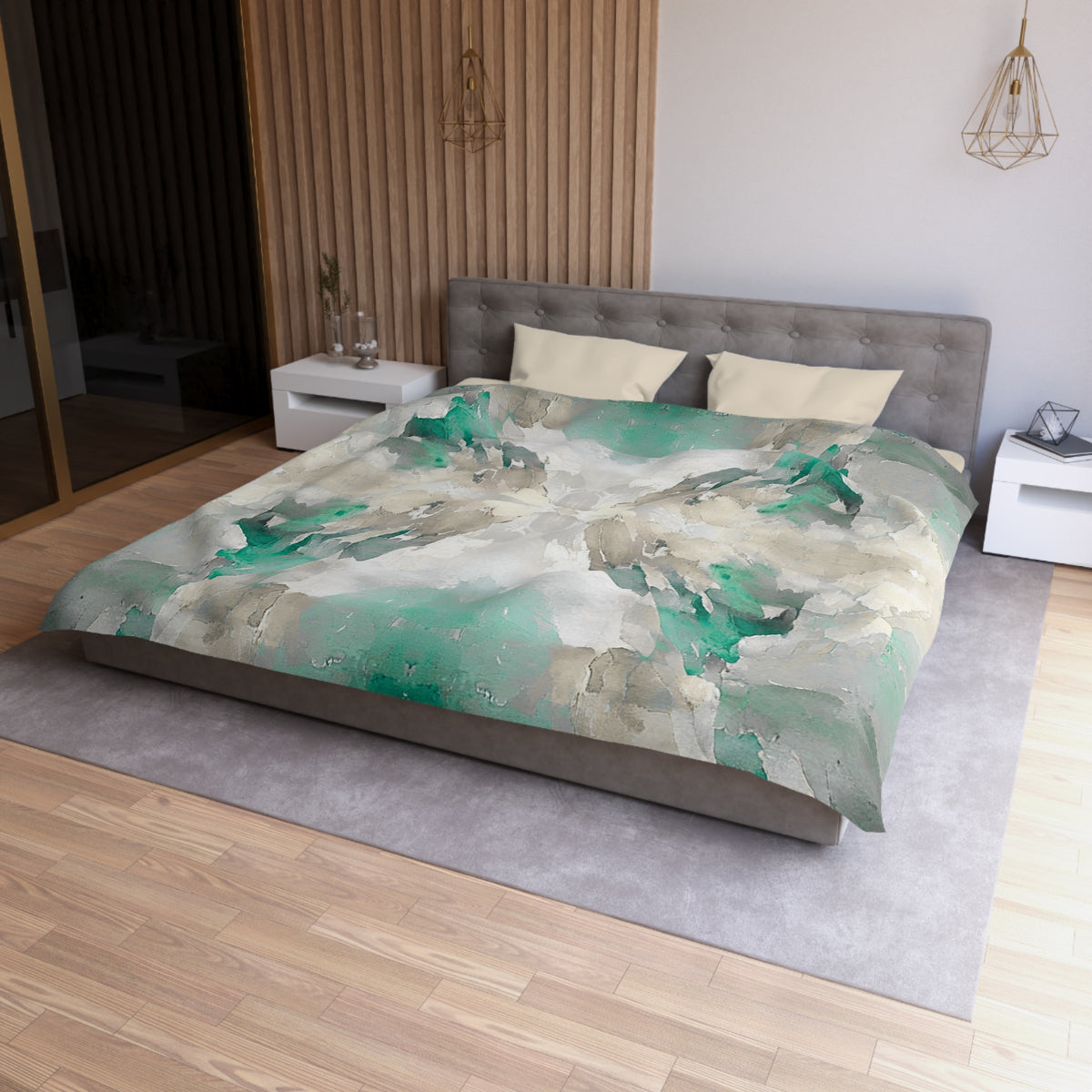 a modern bedroom with a large bed, a gray headboard, and a gray and white color scheme. The bed is covered in a green and white abstract patterned comforter. The room has a wooden floor and white walls, creating a clean and minimalist aesthetic.