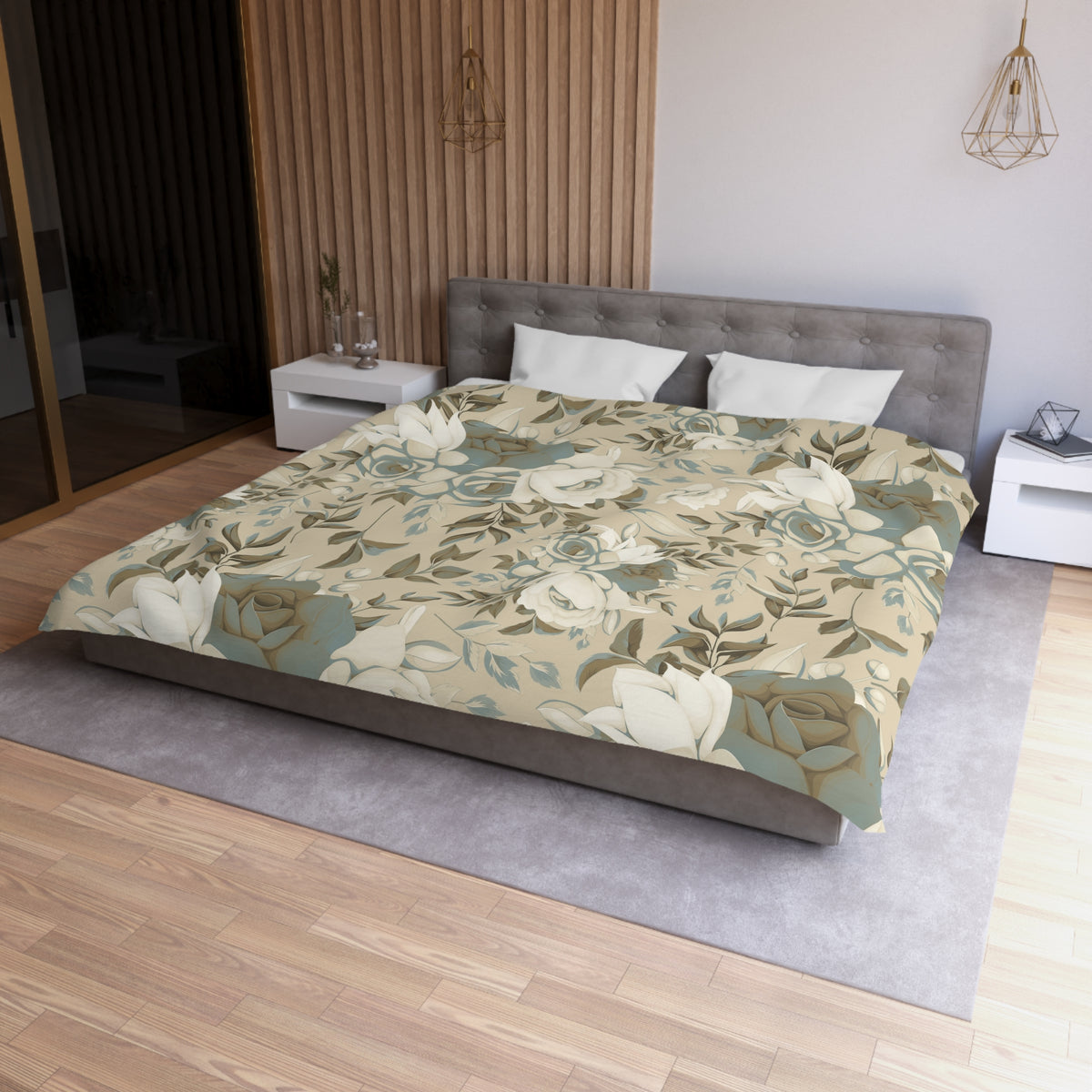 a modern bedroom with a large bed covered in a floral print comforter. The bed is positioned against a wall with a wooden panel design. The room has a neutral color scheme with a gray headboard and white pillows. There are also two nightstands on either side of the bed, and a pendant light hangs above the bed.