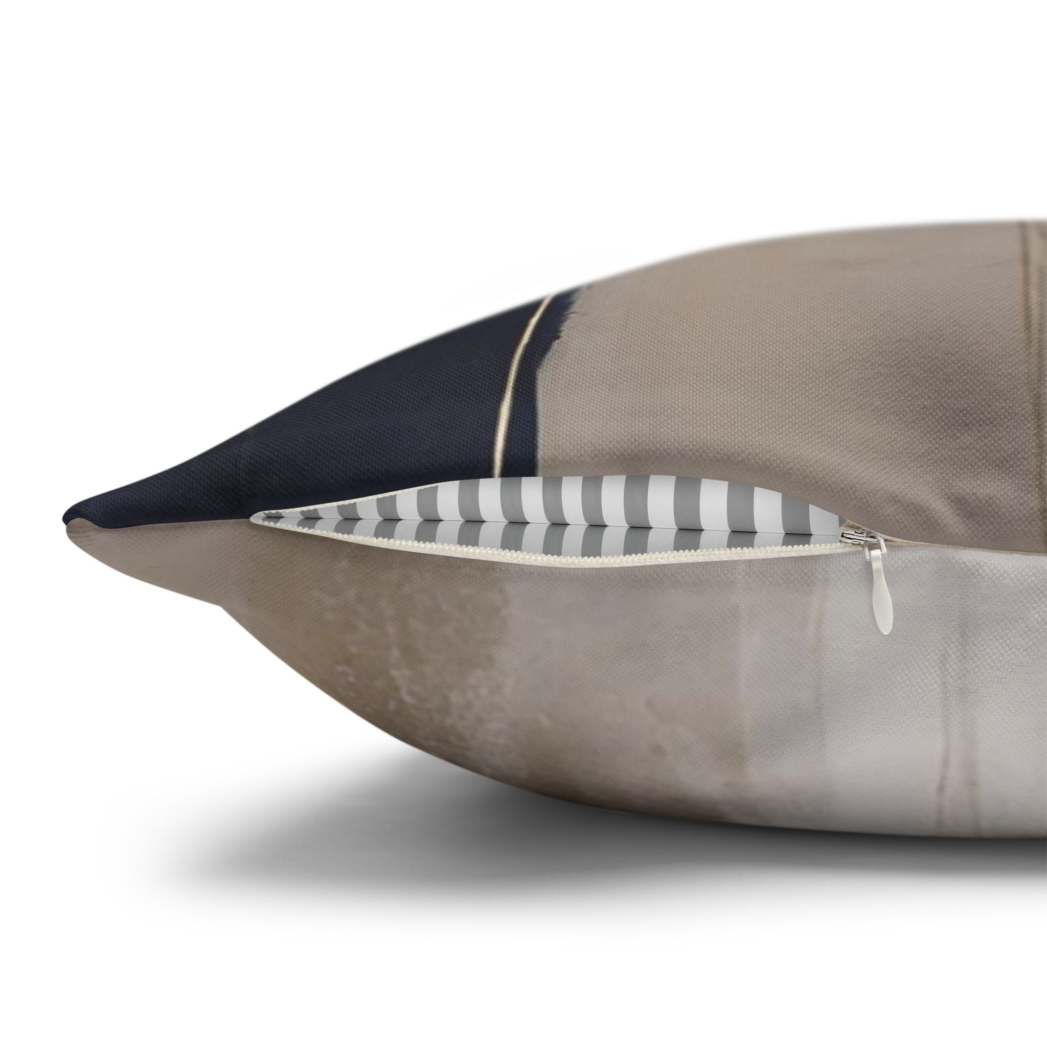A close-up view of a pillow with a black and white striped pattern, partially unzipped.