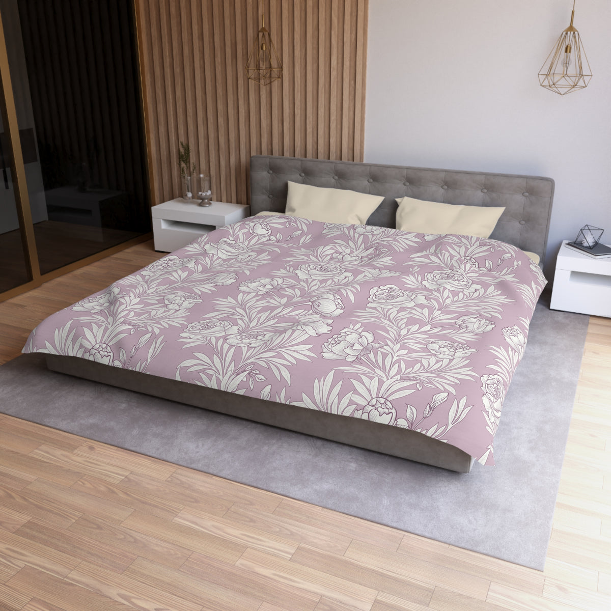 a modern bedroom with a large bed, a gray headboard, and a floral patterned comforter. The room has a wooden floor and white walls, creating a serene and elegant atmosphere.