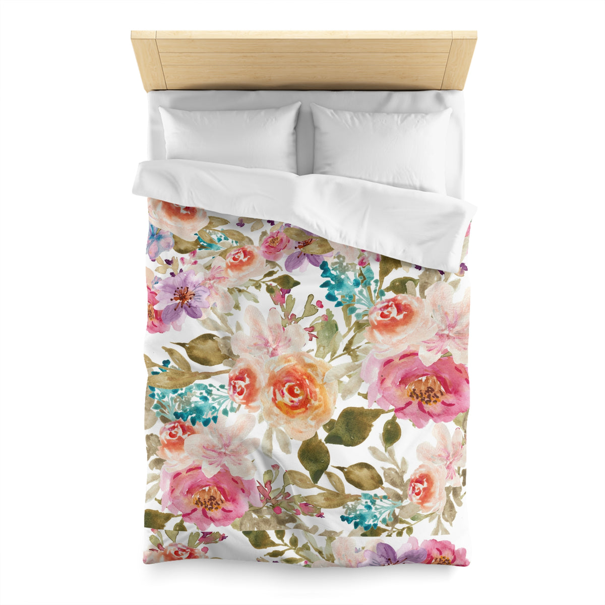 a bed with a floral print duvet cover and pillows.