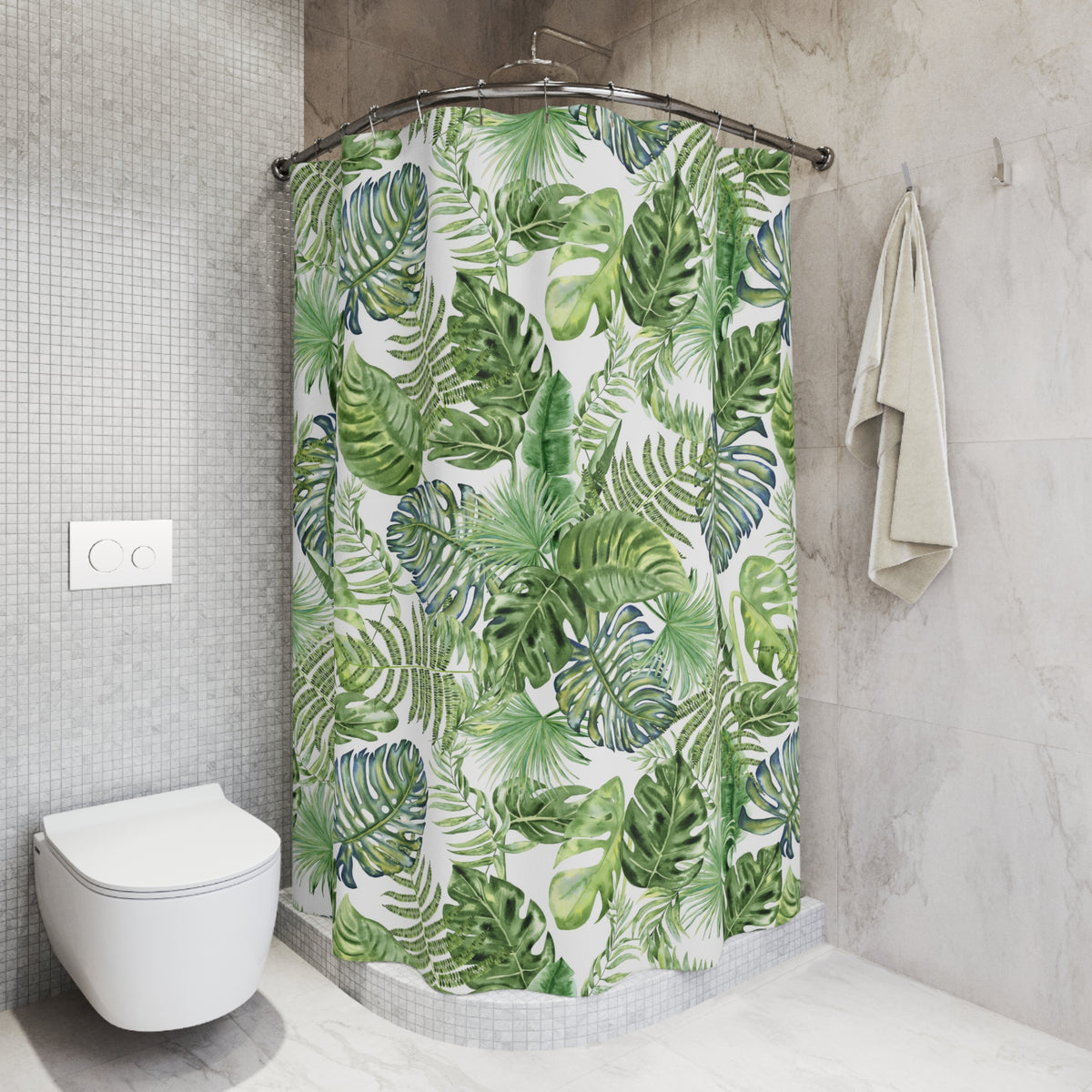 a bathroom with a shower curtain adorned with a tropical leaf pattern in shades of green and white. The shower curtain is hanging from a rod next to a towel rack. The bathroom has a white toilet and a tiled wall, creating a clean and modern aesthetic.