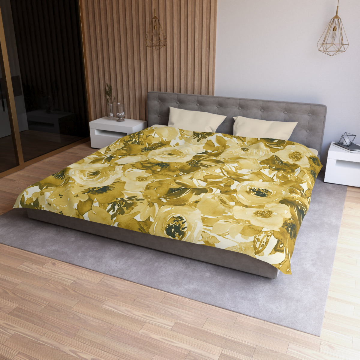 a modern bedroom with a large bed covered in a yellow and green floral comforter. The bed is positioned against a wall with a wooden panel. The room also features a nightstand, a pendant light, and a vase on a surface.