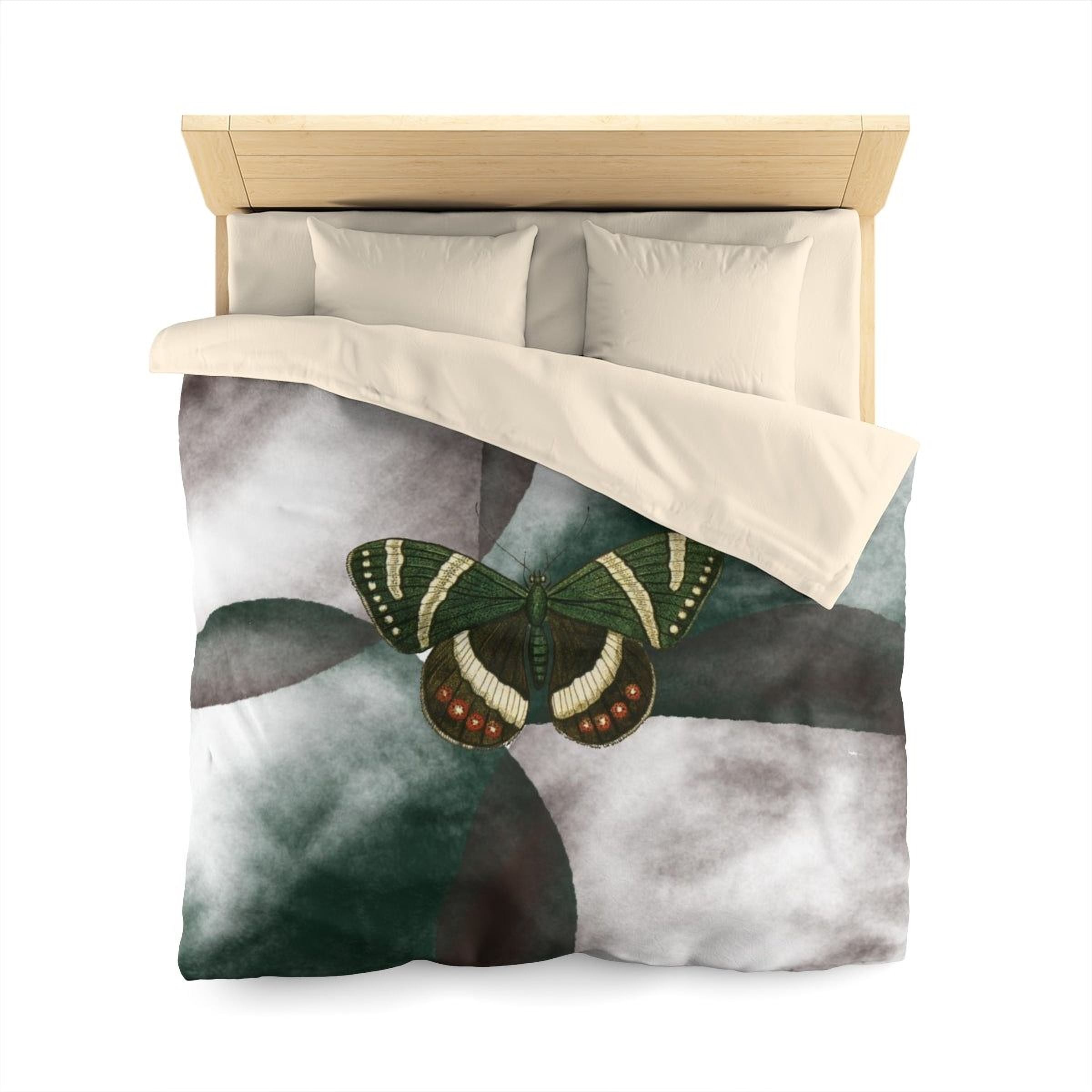 a bed with a green and white butterfly design on the comforter.