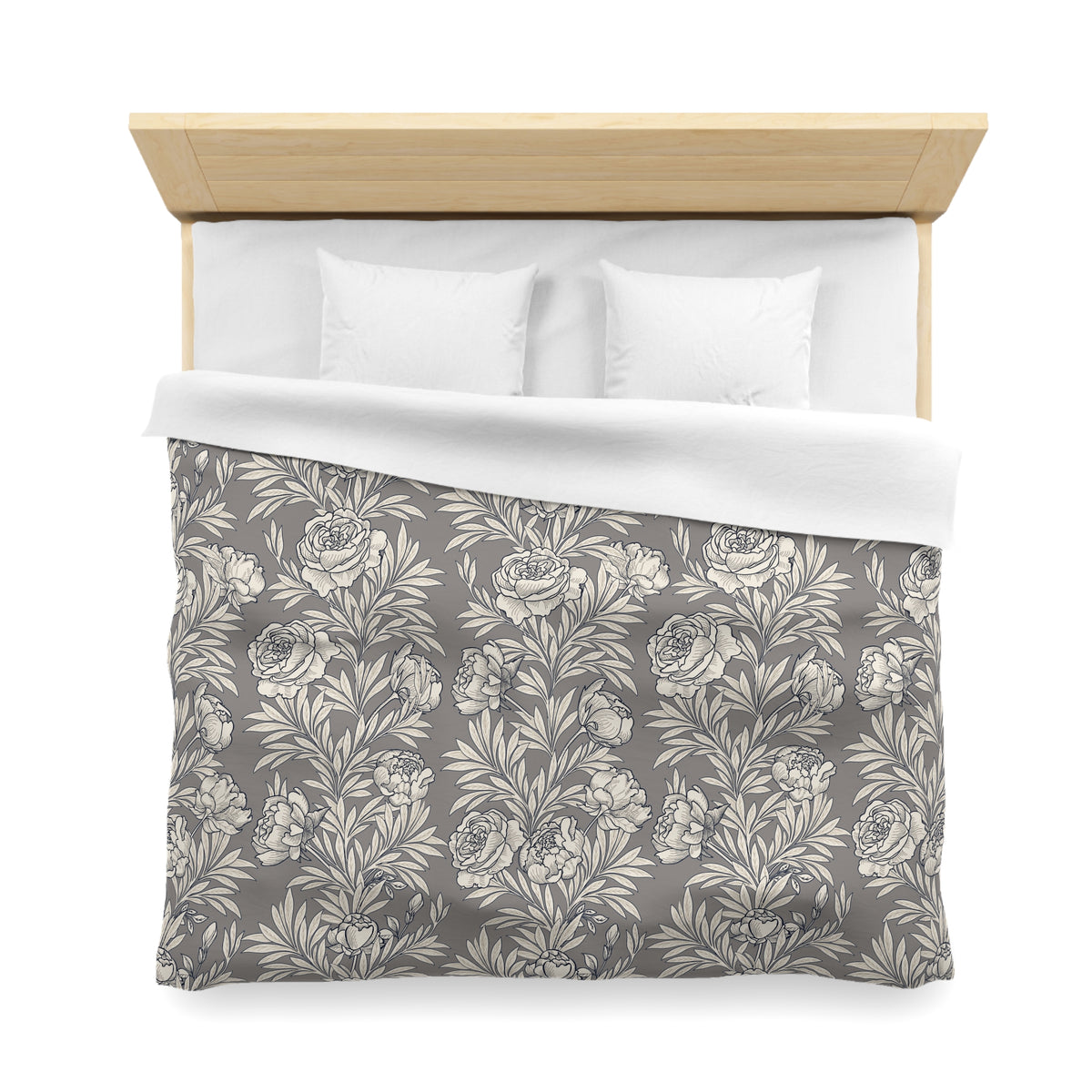 a neatly made bed with a gray and white floral patterned comforter and two white pillows.